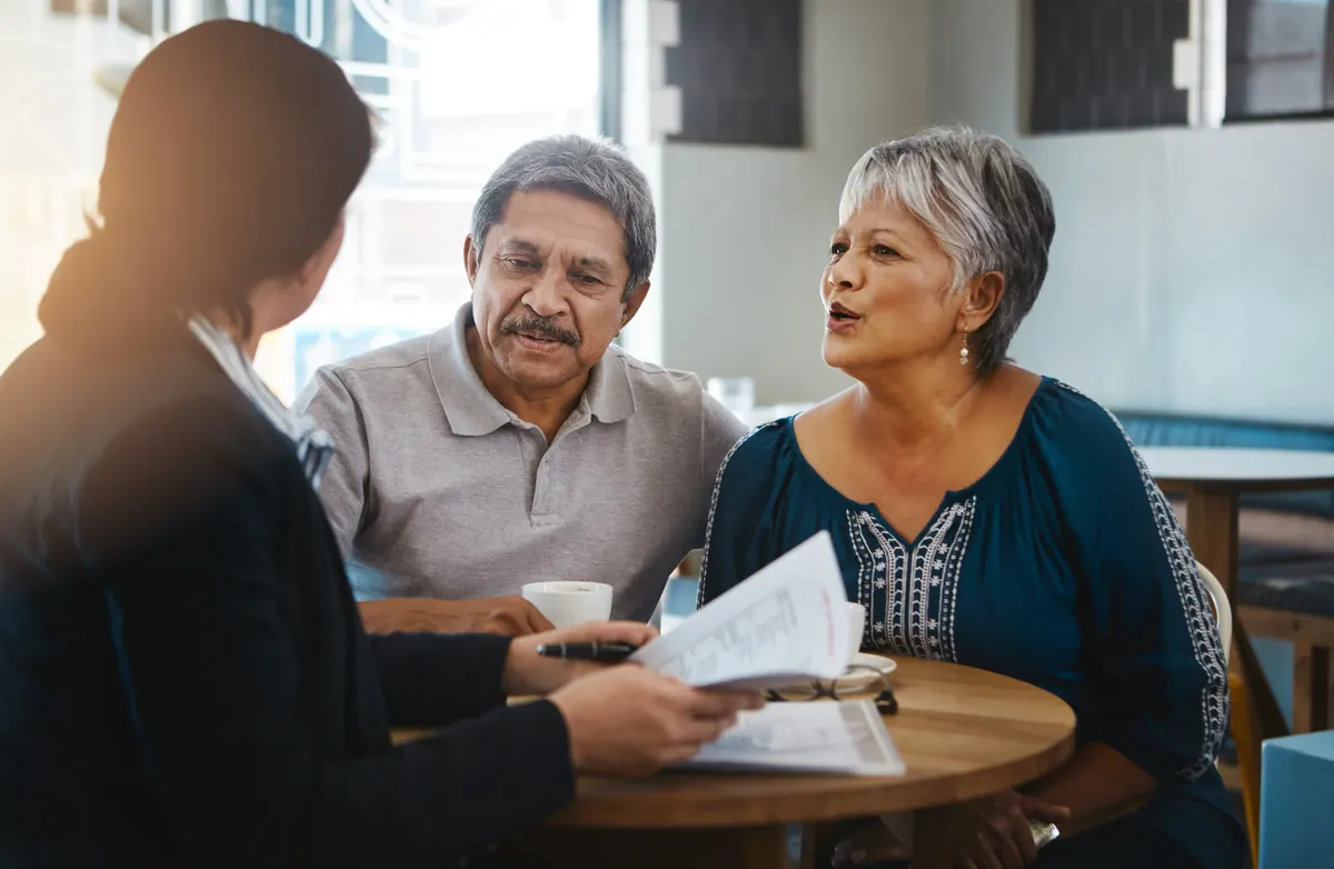 Couple reviewing documents with an advisor