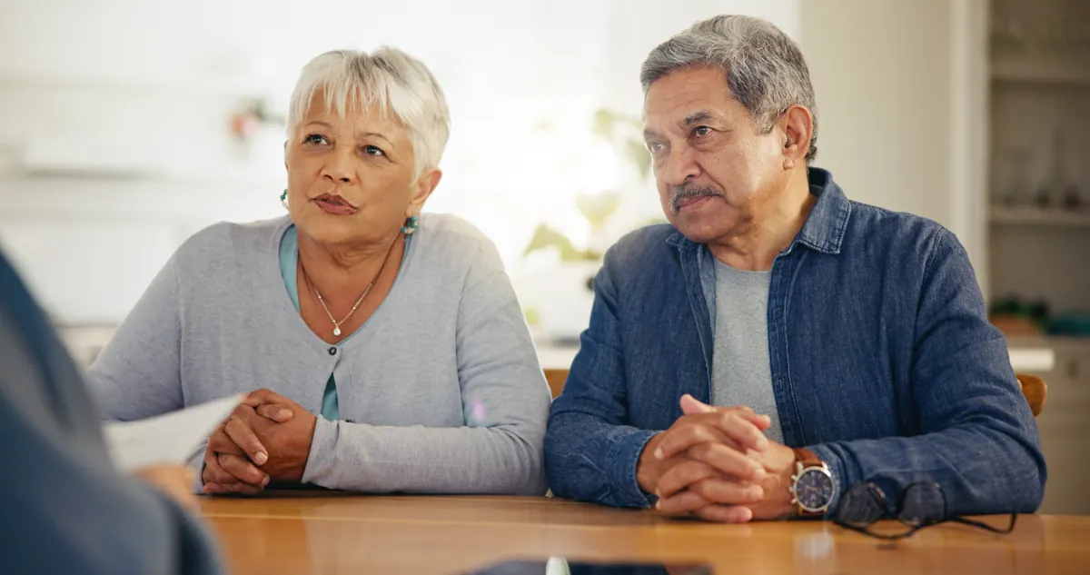 Couple listening during a meeting at a kitchen table