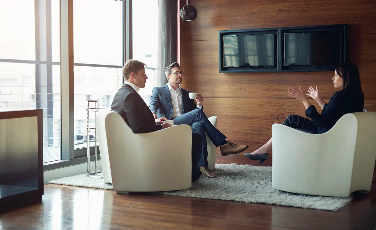 Attorney meeting with clients in a bright office
