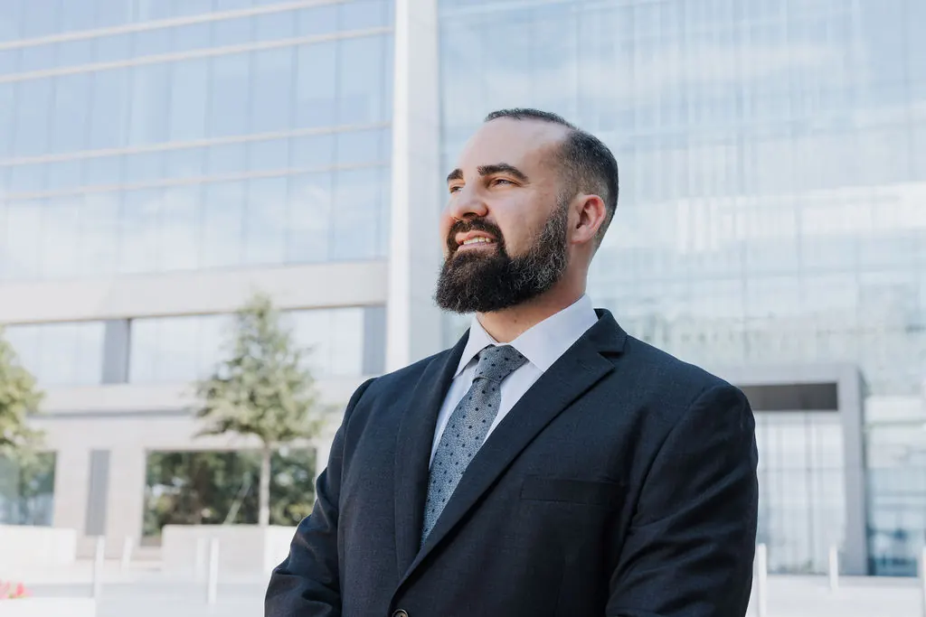 Travis McBride, managing attorney, outside an office building