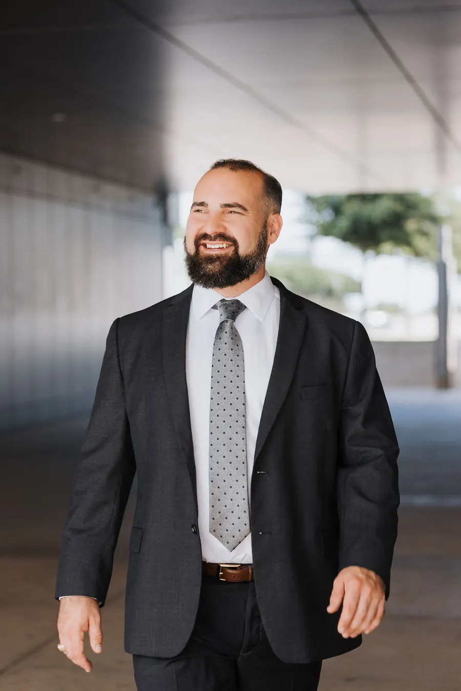 Travis McBride smiling while walking